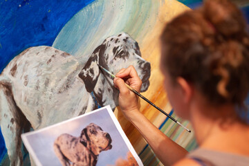 Female Painter Painting Image of a Dog from a Photograph With Acrylic Colors on Canvas Close up