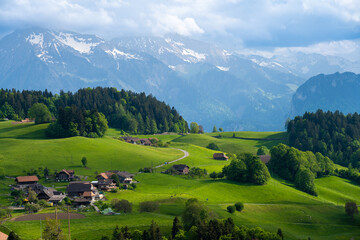 amazing view on green hills and Alps in village near Thun in Switzerland