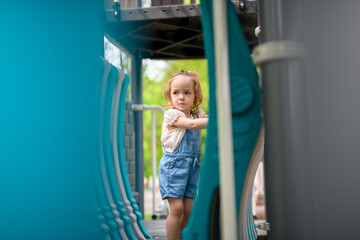 Child playing on outdoor playground. Active kid on playground summer activity for children