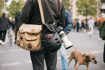 Faceless reporter at work in the street