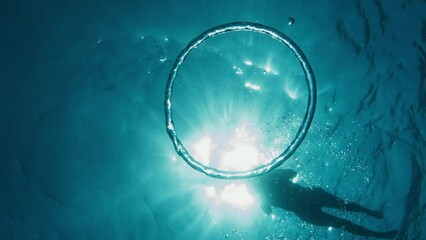Ring bubble moves underwater towards the surface