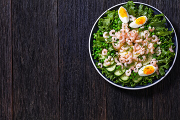 pink cocktail shrimps salad with veggies on plate