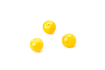 Three yellow cherry tomatoes on a white background