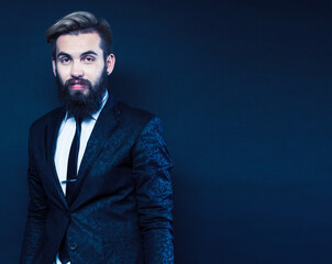 young attractive bearded hipster man gesturing emotional screaming in studio sucsess. fashion modern brutal guy