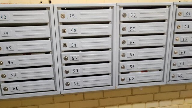 Gray mailboxes close-up in a modern apartment building, residential real estate. Mailboxes for letters, newspapers and magazines