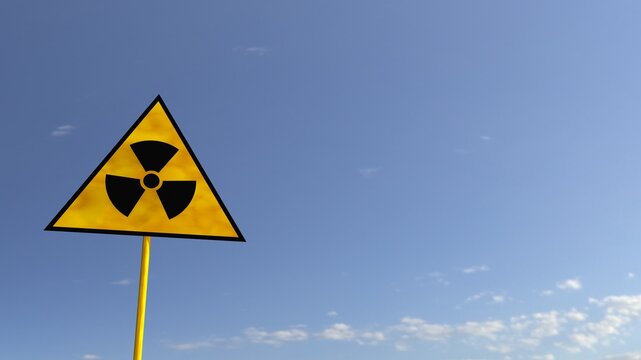 Radiation sign on a against the sky and greenery. 3D render
