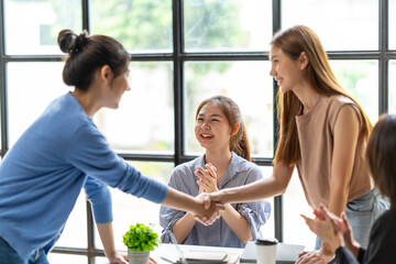 Business people shaking hands, finishing up a meeting, business woman asian team partners in the office.