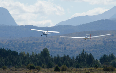 Fototapeta na wymiar ultralight glider towed by propeller plane