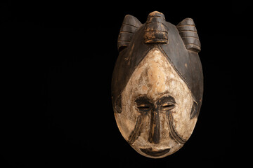 Fototapeta na wymiar African mask on a black background