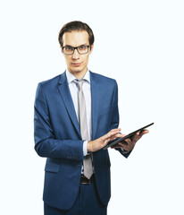 Handsome man in glasses and classic suit with digital tablet isolated on white background