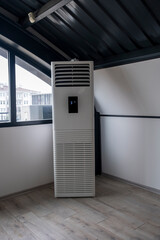 vertical Tower air conditioner indoor unit in loft office. Selective Focus machine