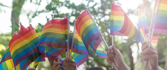 LGBT, pride, rainbow flag as a symbol of lesbian, gay, bisexual, transgender, and queer pride parade and LGBTQ social movements in June month - obrazy, fototapety, plakaty