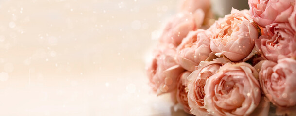 Bouquet of pink roses on a gentle blurred background with copy space. Pink banner with beautiful pink flowers.