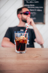 person drinking cocktail