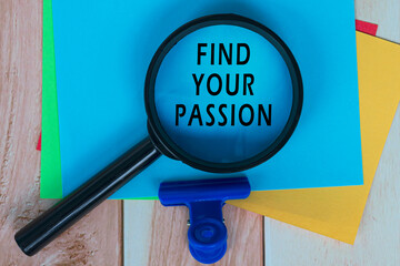 Find Your Passion on Blue Adhesive Note With Magnifying Glass On Wooden Desk.