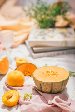 Cantaloupe melon slice near glass placed on white table