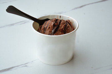 Chocolate ice cream in a white cup
