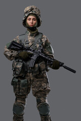 Photo of patriotic militant woman holding rifle dressed in camouflage clothes.