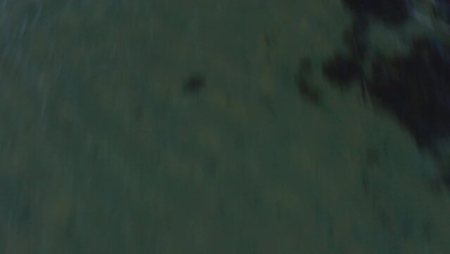Aerial shot flying over the sea in fast motion, in Brittany, France