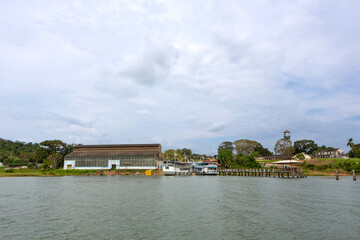 Fototapeta premium Beautiful view of Fordlandia city skyline in Amazon rainforest, Brazil. Tapajos river and historic water tank tower. Town built by Henry Ford in 1928 to produce rubber in the middle of the forest.