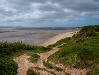 A clifftop view from the Wirral Country Park at Thurstaston looking down to the beach and across...