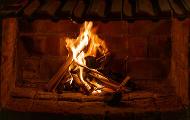 photograph of flames in the fireplace. Burning wood. Brick fireplace