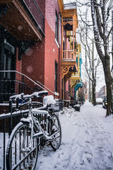 Fototapeta na wymiar View of Roy street and snow-covered bike in Plateau Mont-Royal neighborhood on a snowfall day in Montreal, Quebec (Canada)