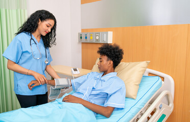 Nurse use machine to measure blood pressure of patient lie on bed in hospital.
