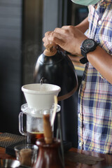 Fototapeta na wymiar Barista brewing coffee, method pour over, drip coffee