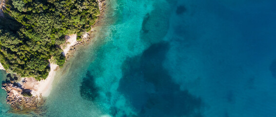 Relaxing aerial beach scene, summer vacation holiday template banner. Waves surf with amazing blue ocean lagoon, sea shore, coastline. Perfect aerial drone top view. Peaceful bright beach, seaside