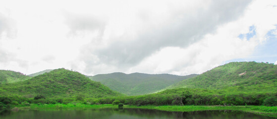 Lake at the Foot of the Mountain with a Beautiful Forest, Blue Sky, and Stunning Clouds - Brazilian Landscape