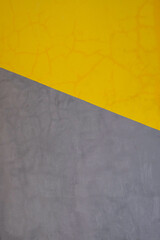 Yellow and gray geometric design painted on cement wall in Bali, Indonesia