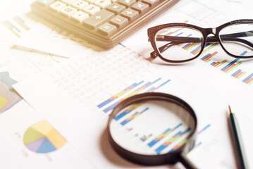 Obraz premium Calculator with pen on stock market analysis. Concept of Business, Finance and Audit research.
