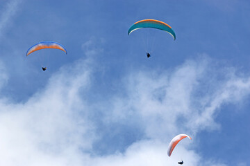 Paragliders in a blue sky	