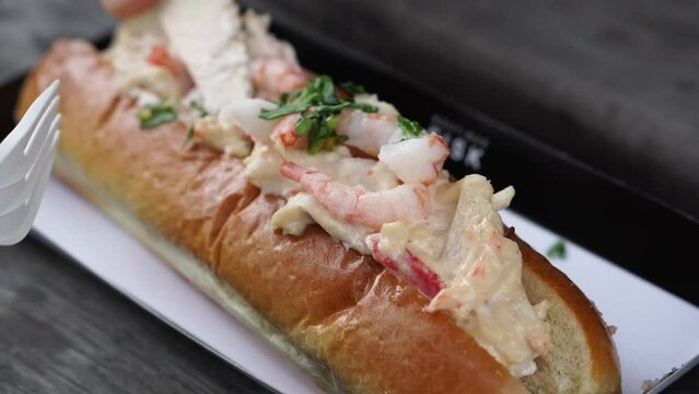 Eating sharing lobster seafood roll sandwich