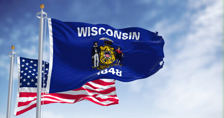 The Wisconsin state flag waving along with the national flag of the United States of America - obrazy, fototapety, plakaty