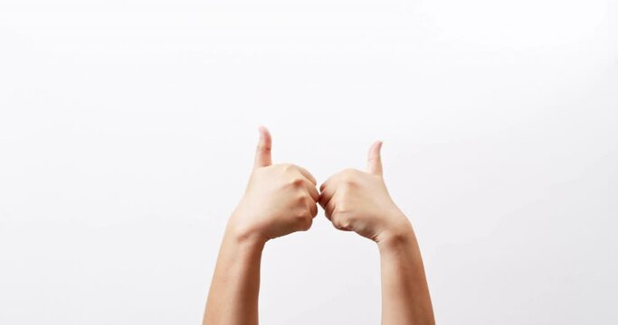 Close up of Woman's hands showing and making thumb up sign isolated on a white studio background with copy space for place a text, message for advertisement and product promotional.