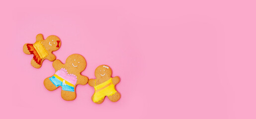 Gingerbread man, mom and two girls on a pink background. Banner  for text about mother's day or family day.