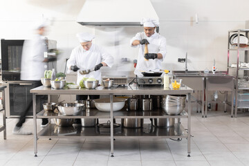 Chef cooks working in professional kitchen. Chefs hurry up, actively cooking meals for restaurant....