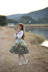 A beautiful woman in lolita dress in garden background Japanese street fashion portrait