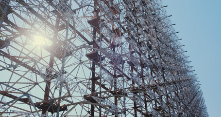 Chernobyl 2, an antenna for tracking intercontinental missiles, an abandoned secret military facility. A giant wall of metal antennas, the sun shines through the structure.