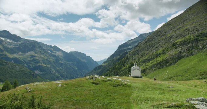 Wide shot of a small church in the Italian alps with a great landscape behind it. It is named Sant'Anna, and it's located in Gressoney La Trinitè, in Valle d'Aosta
