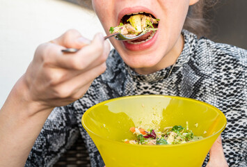 Woman eating a fresh vegan salad