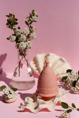 Menstrual cup eco-friendly reusable and silicone and flowers on a pink background