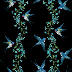 Embroidery seamless pattern with blue forget-me-not flowers and  swallows  on a black background. - 506906227