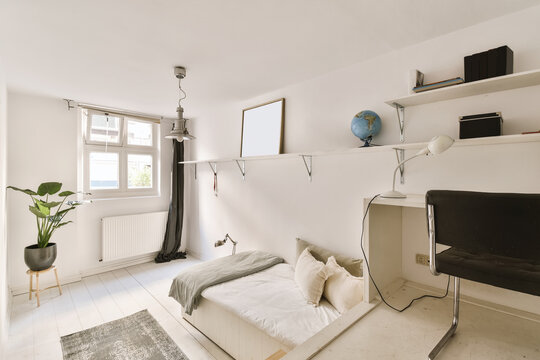 Contemporary white bedroom interior with cozy bed and working zone