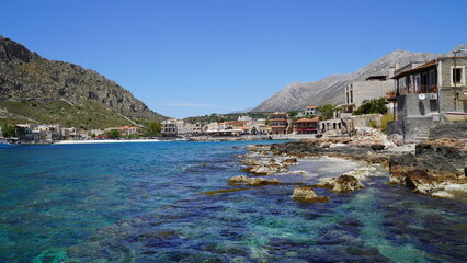 Greek village on the seaside. Rocks and sea water