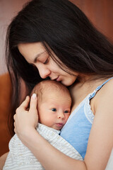 Young mother holding her cute newborn baby