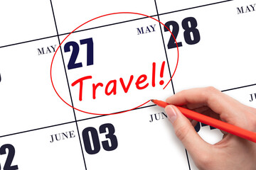 27th day of May. Hand drawing a red circle and writing the text TRAVEL on the calendar date 27 May....