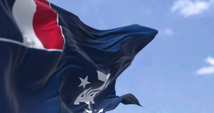 Seamless loop in slow motion of the flag of the French Southern and Antarctic Lands waving in the wind on a clear day